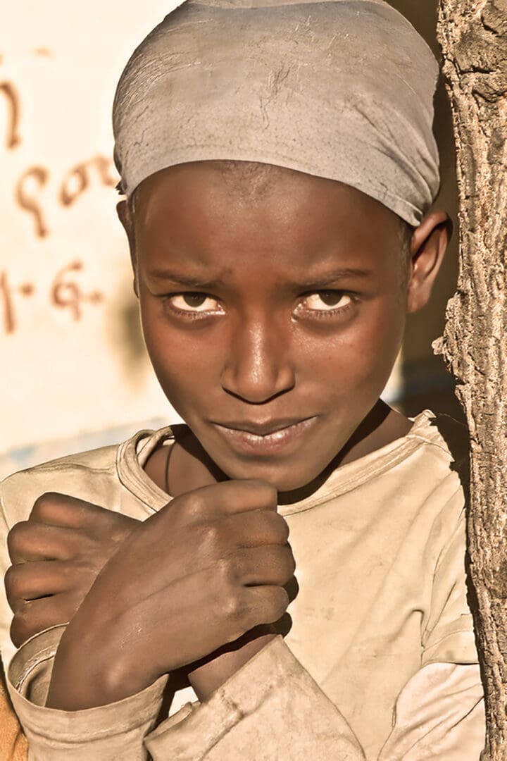 A young boy with his fist raised in the air.