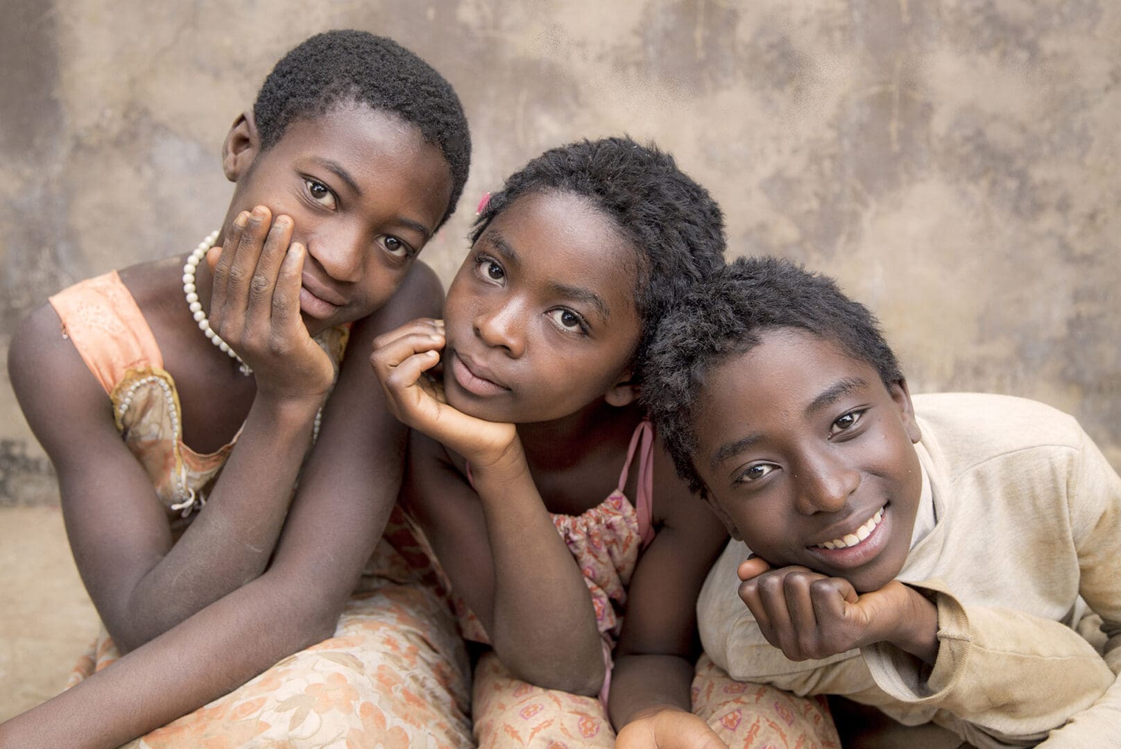 Three young people are posing for a picture.