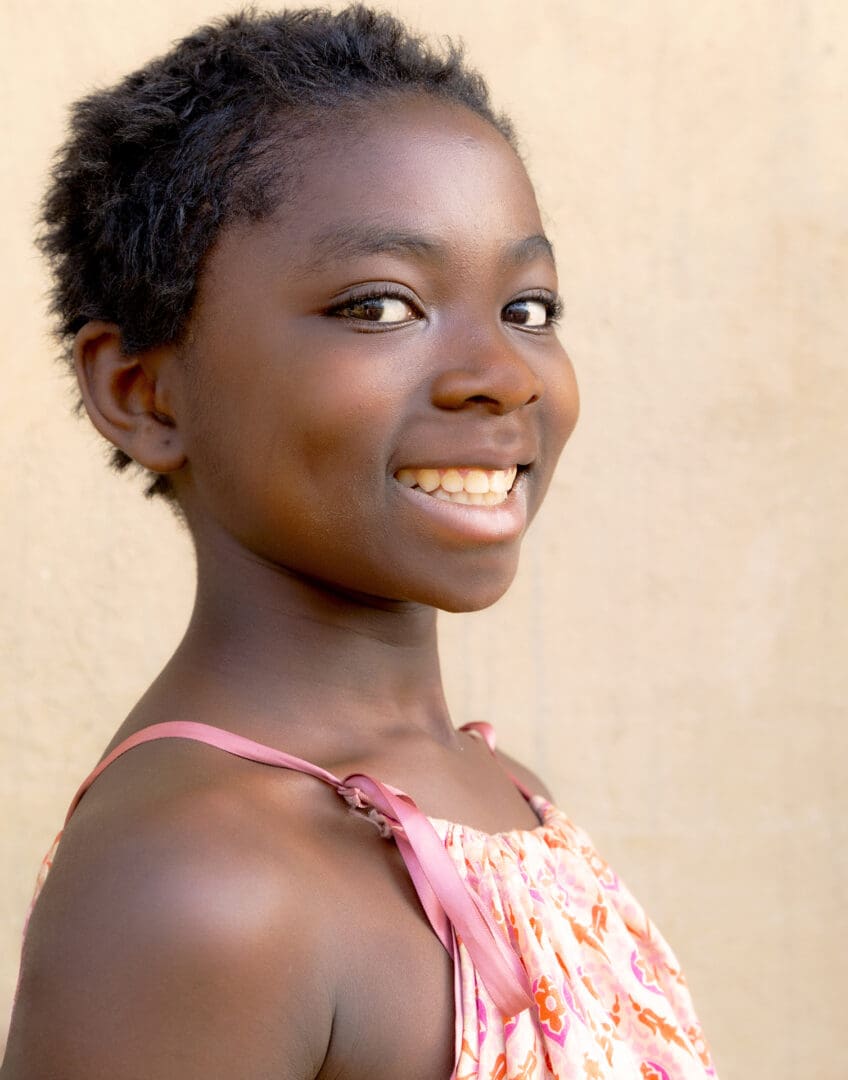 A young girl smiling for the camera.