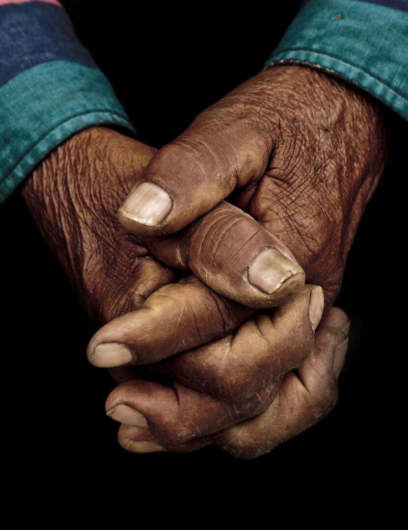 A close up of two hands with dirty fingers