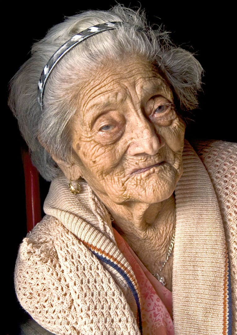 An old woman with a white hair and blue eyes.