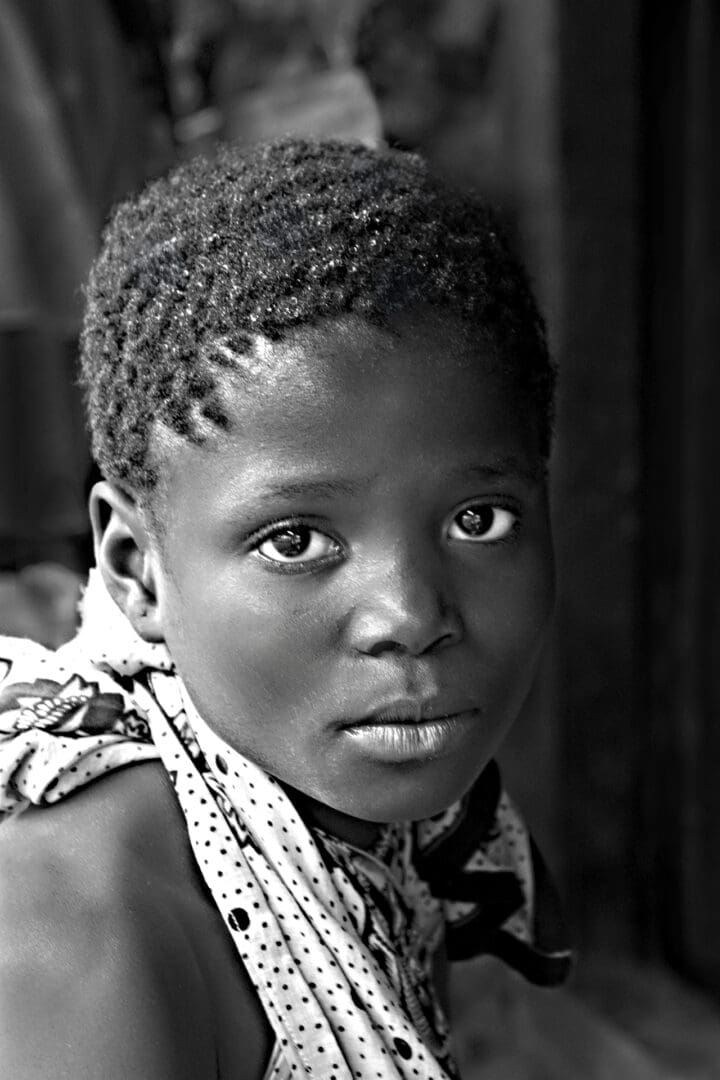 A young boy with a scarf around his neck.