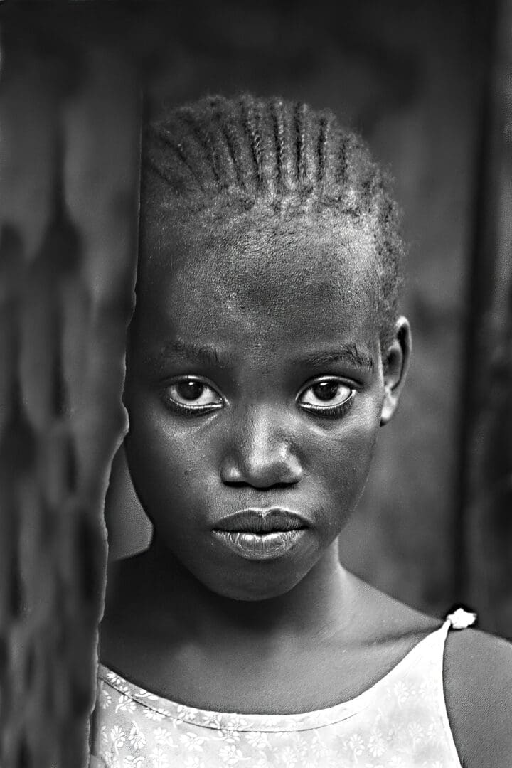 A young girl with very long hair and a large head.