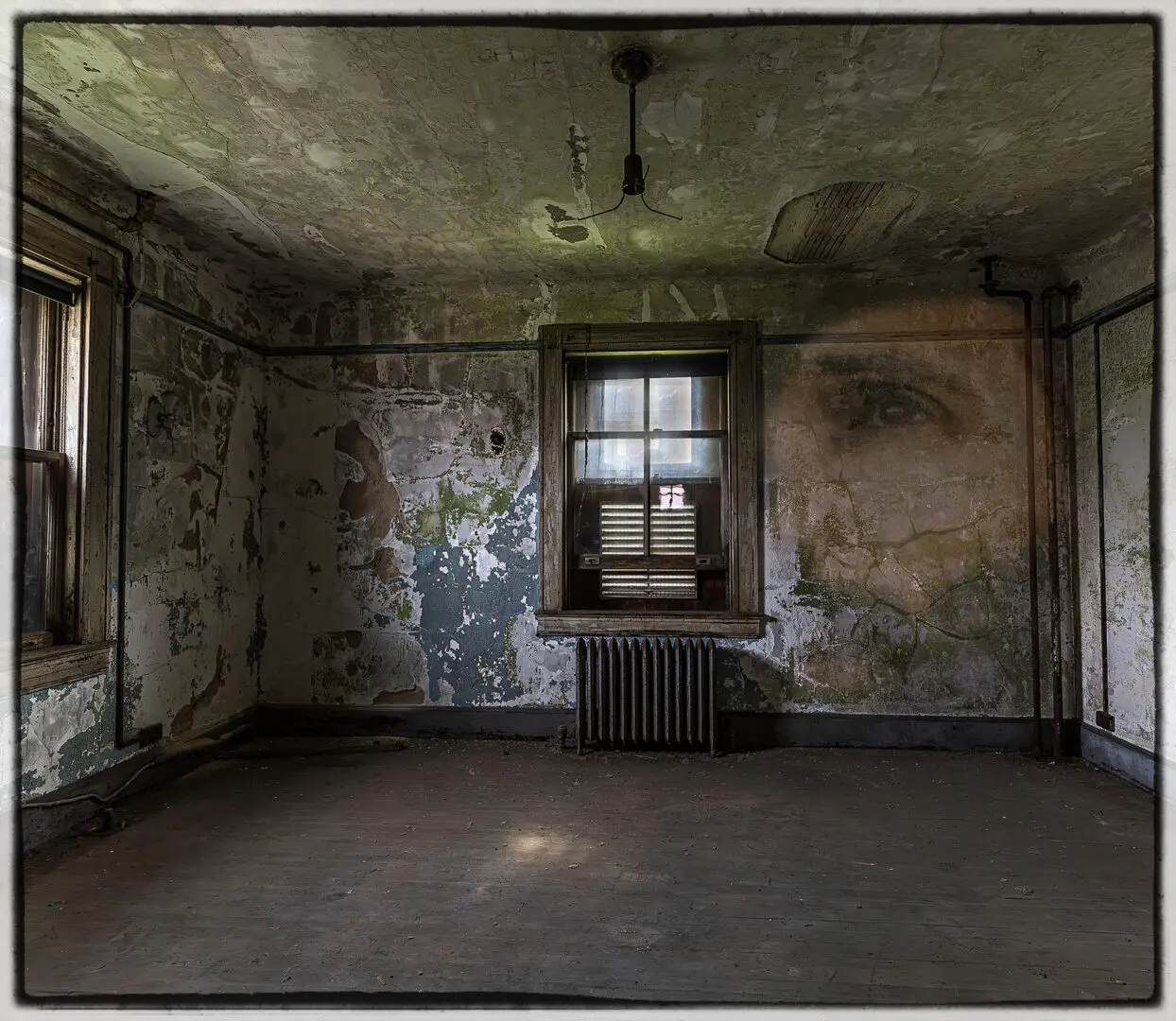 A room with a window and a radiator in it