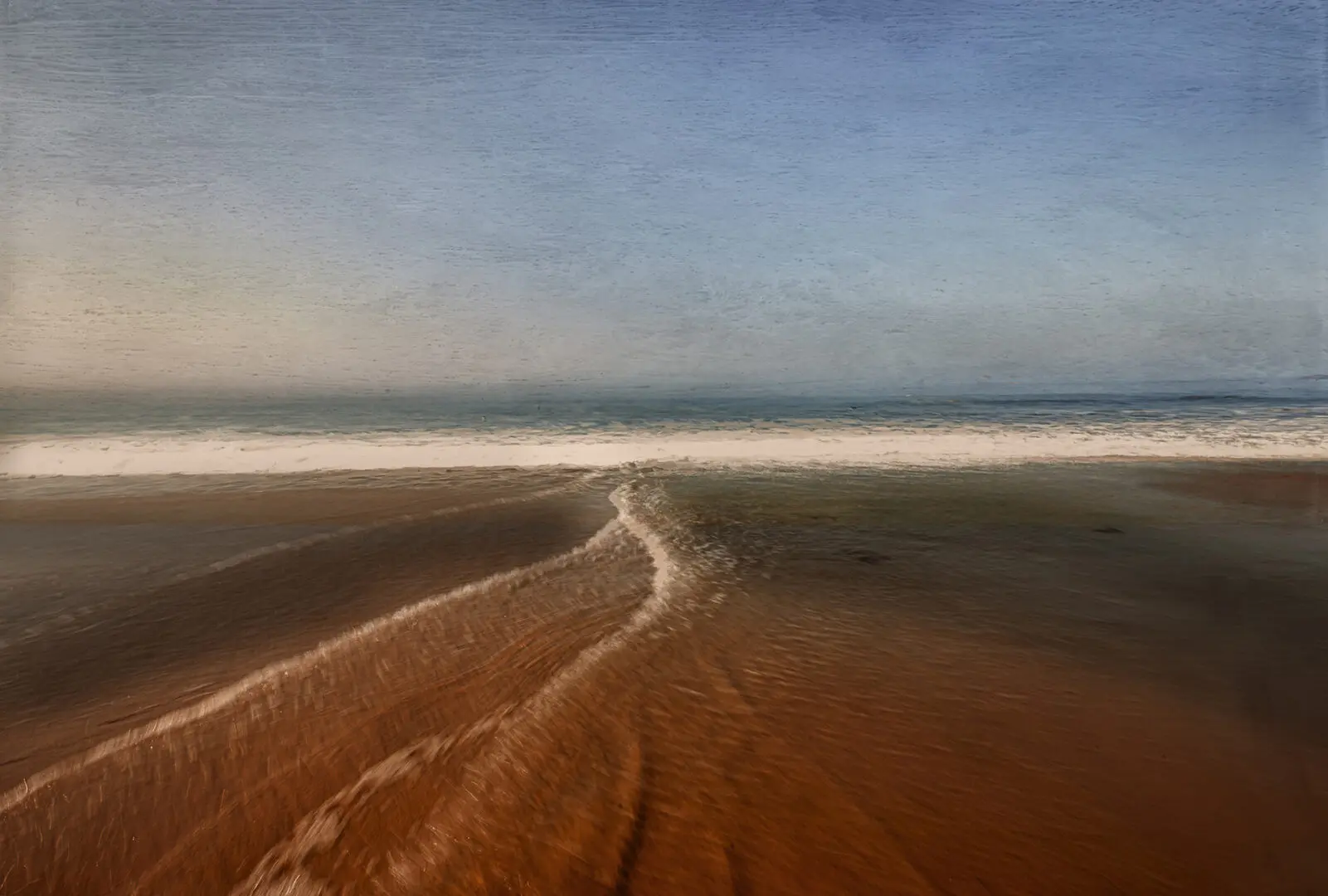 A beach with sand and water on it