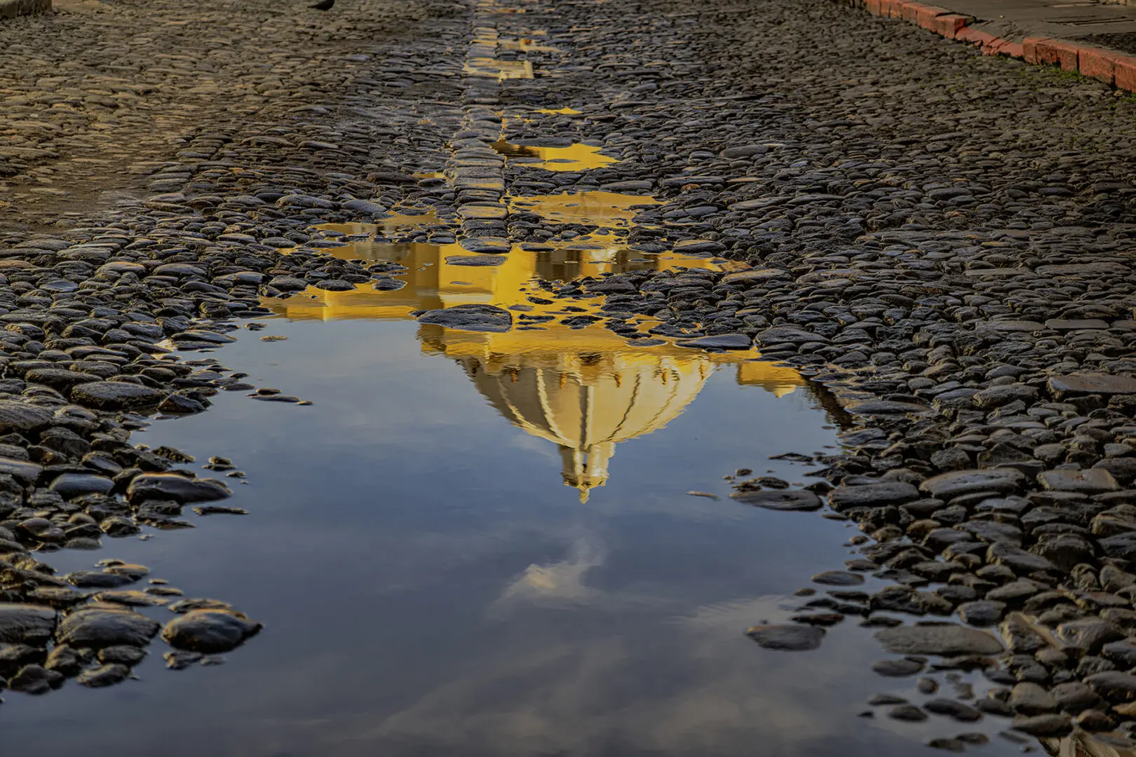 A reflection of the sky and clouds in water.