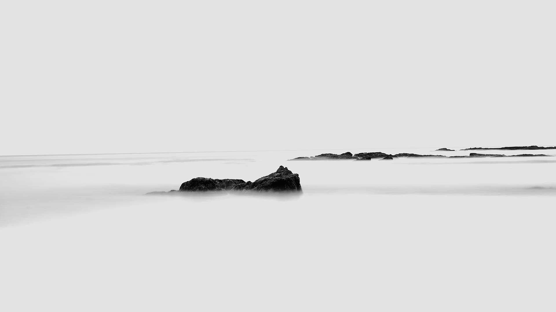 Black and white long-exposure sea rocks