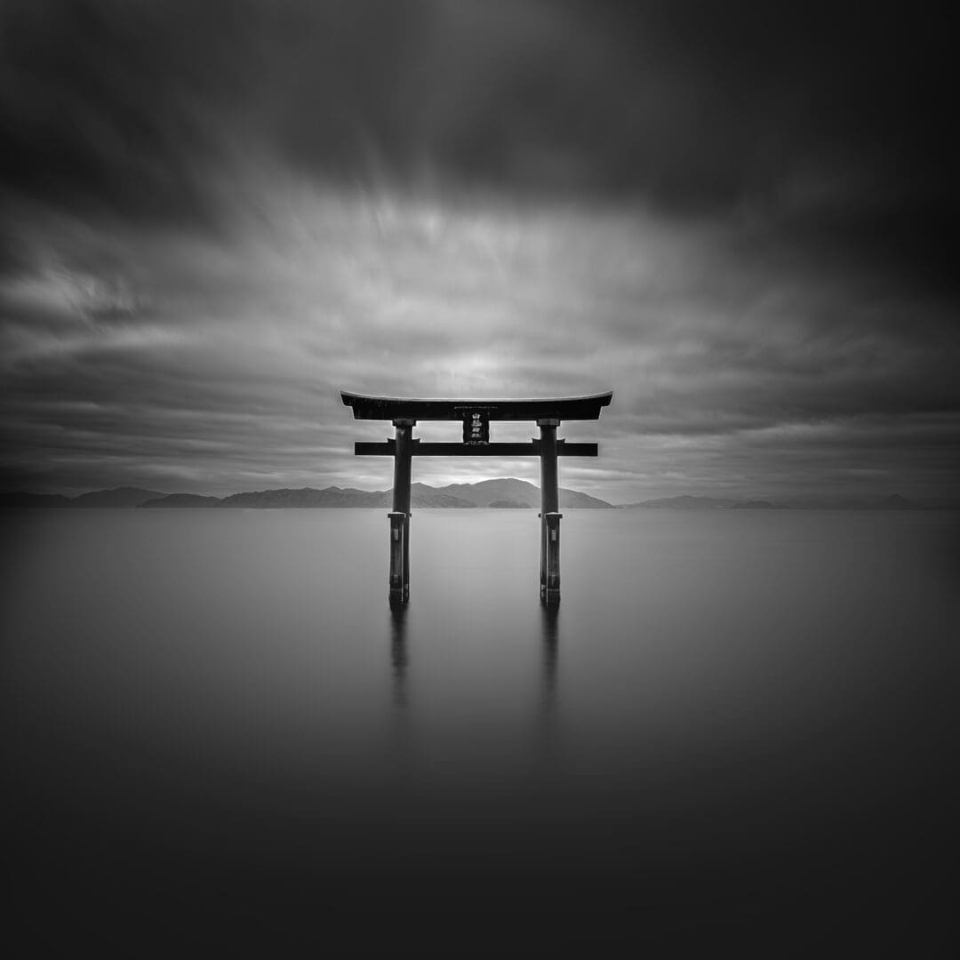 Solitary torii gate in tranquil water