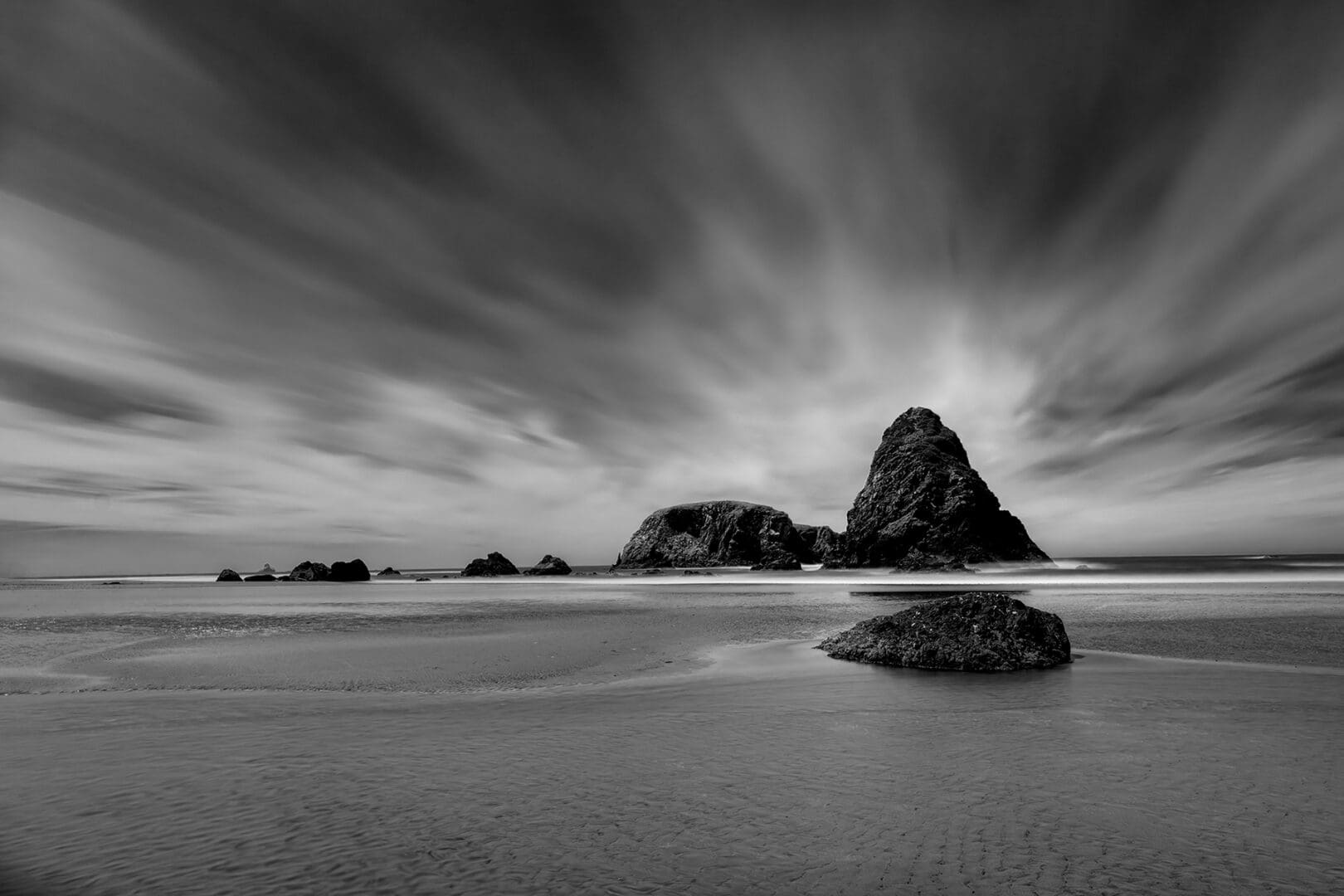 Black and white sea stack on beach