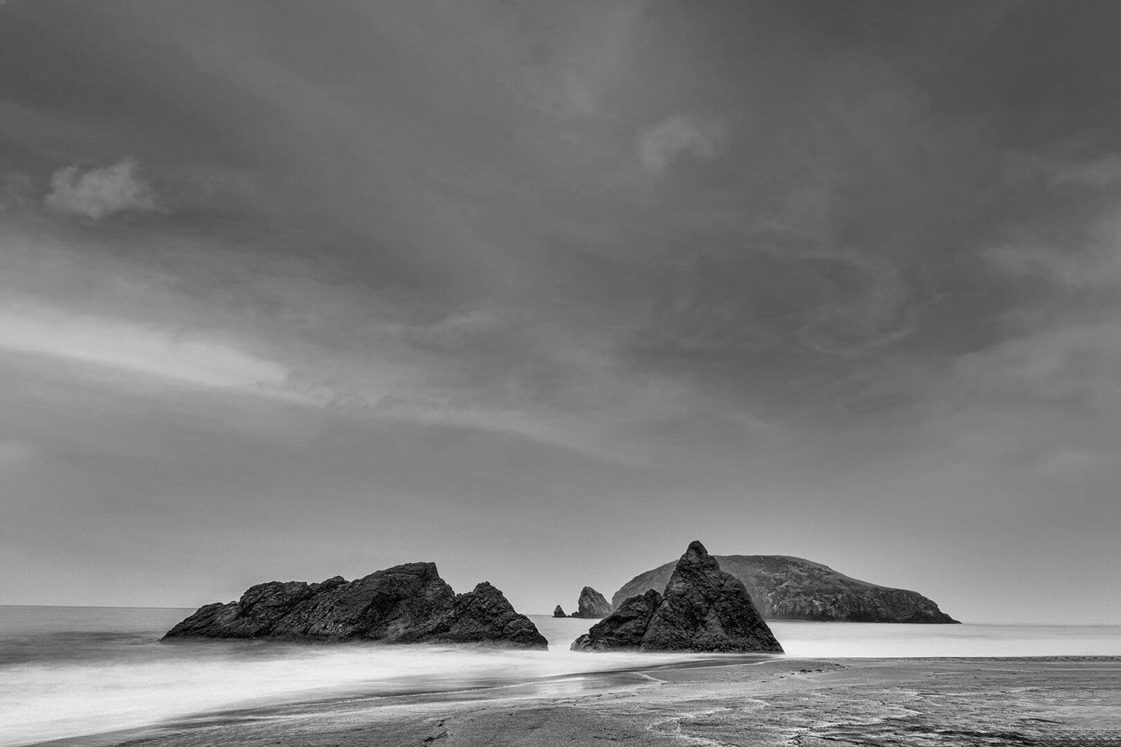 Monochrome seascape with rocky shoreline
